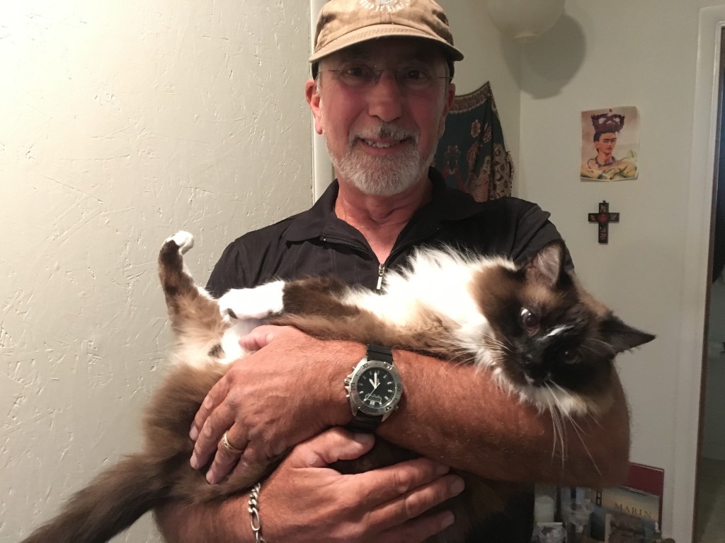 Rick holding our former cat  PO in the way only Daddy can